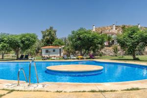 a large swimming pool in front of a house at La Higuera in Benalúa de Guadix