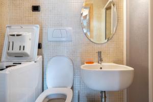a bathroom with a white toilet and a sink at Apartment Vajolet in Campitello di Fassa +23 photos