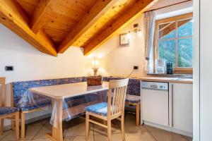 a kitchen and dining room with a table and chairs at Apartment Vajolet in Campitello di Fassa