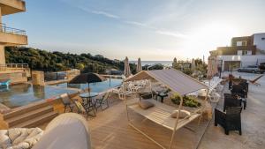 a patio with a pool and chairs and a table at Aurora Apartments with Pool in Bar