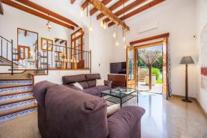 a living room with a couch and a glass table at Son Calletes in Artá