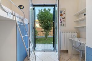 a glass door leading into a room with a plant at La Casa Di Freddy - Loano in Loano +23 photos