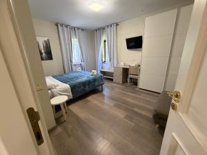 a bedroom with a bed and a desk and a table at La Coccinella in Iesi +58 photos