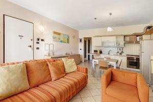 a living room with a couch and a kitchen at La Casa Di Freddy - Loano in Loano
