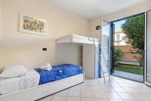 a bedroom with a bunk bed and a balcony at La Casa Di Freddy - Loano in Loano