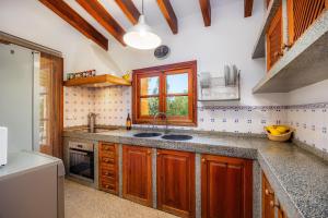 a kitchen with a sink and a window at Son Calletes in Artá