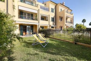 a pair of chairs sitting in the yard of a house at La Casa Di Freddy - Loano in Loano