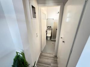 a hallway leading to a bathroom with a toilet at aeolian blu 9 in Parikia