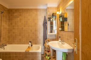 a bathroom with a sink and a bath tub at Casa Curumbico in Almuñécar +22 photos