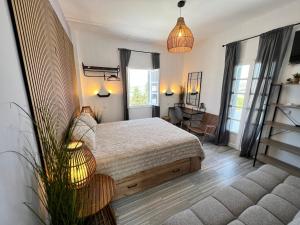 a bedroom with a bed and a desk and windows at aeolian blu 9 in Parikia