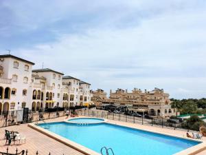 a large swimming pool in front of some buildings at Good Atmosphere in Orihuela