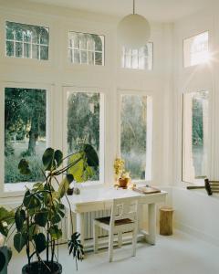 a room with a white desk in front of windows at CHB - Château de la Haute Borde in Rilly-sur-Loire