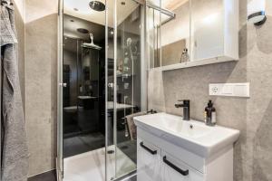 a bathroom with a sink and a shower at Naturpur Tinyhouse in Osterrade +20 photos