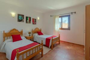 a bedroom with two beds and a window at Hortet in Campos +22 photos