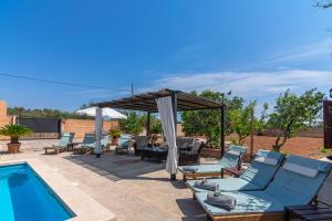 a patio with chairs and a swimming pool at Hortet in Campos
