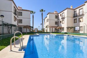 a swimming pool in front of two buildings at Casa Cox Laguna Beach Torrox Costa in Torrox Costa