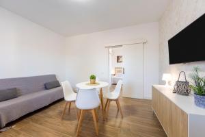 a living room with a table and chairs and a couch at La palmera in Níjar