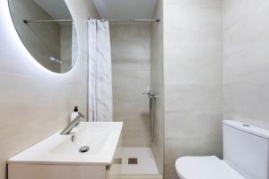 a bathroom with a sink and a toilet and a mirror at La palmera in Níjar +15 photos