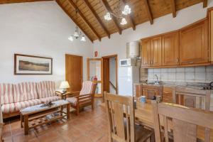 a kitchen and living room with a couch and a table at El Ciruelo in Valverde
