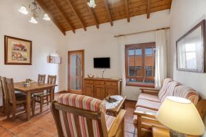 a living room with a couch and a table at El Ciruelo in Valverde