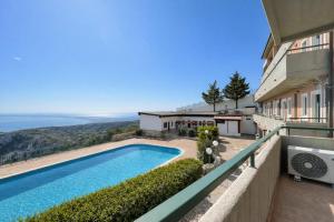 a house with a swimming pool on a balcony at Santangelo in Monte SantʼAngelo