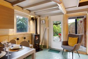 a living room with a table and chairs and a fireplace at Haus am Gardasee mit Seeblick in Raffa +17 photos