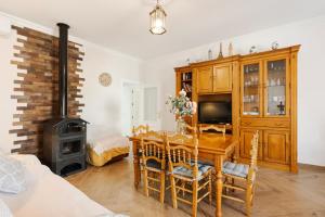 a living room with a dining room table and a stove at Casa Miró in Humilladero