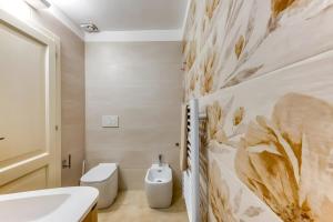 a bathroom with a toilet and a sink at Casa Don Paolo in Alessano +33 photos