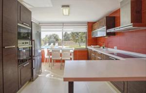 a kitchen with a counter and a table in it at Caleu in Binissalem