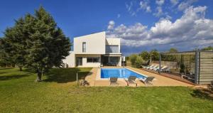 a house with a swimming pool in the backyard at Caleu in Binissalem
