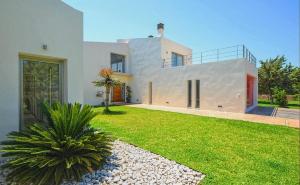 a large white house with a grass yard at Caleu in Binissalem