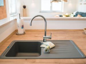 a kitchen sink with a kitchen faucet at Ferienwohnung 12 Kirschen in Durbach +23 photos