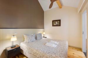 a bedroom with a bed with two towels on it at Orange Apartments A in Porto