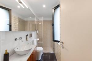 a white bathroom with a sink and a toilet at Orange Apartments A in Porto +16 photos