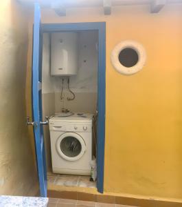 a door to a bathroom with a washing machine at Casa Bohemio - Tabarca in Tabarca
