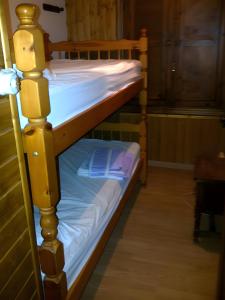 a bunk bed with white sheets and blue sheets at Casa Bohemio - Tabarca in Tabarca
