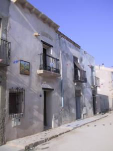 a gray building with balconies on a street at Casa Bohemio - Tabarca in Tabarca