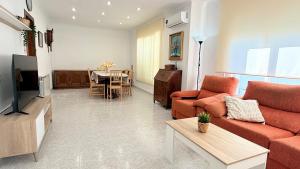 a living room with a couch and a table at Bruc Apartment Beach in Canet de Mar