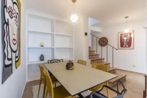 a dining room with a table and chairs at Casa Blanca in Estepona