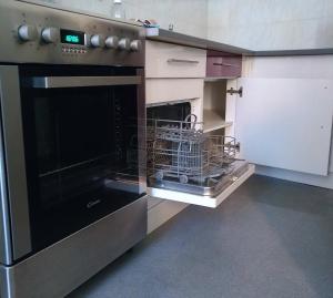 a kitchen with an oven with a dish rack in it at L'appart Millau Centre-Ville - Gite in Millau