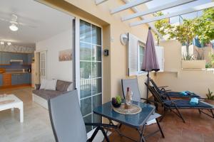 a living room with a table and chairs at Mangueros Suite 18 Puerto de Mogán in Puerto de Mogán