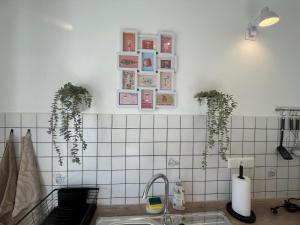 a kitchen with a sink and some pictures on the wall at Am Conradhof 2 in Goch +10 photos
