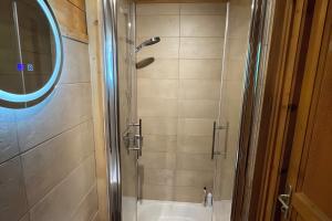 a bathroom with a shower with a toilet and a sink at Chalet Chocolat - 10 pers - Châtel in Châtel +22 photos