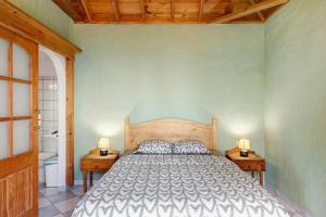 a bedroom with a large bed and two night stands at Villa Gorgonia in Tijarafe