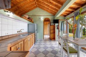 a kitchen with a refrigerator and a table with chairs at Villa Gorgonia in Tijarafe +16 photos