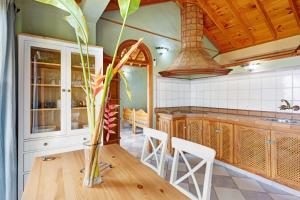 a kitchen with a wooden table with a vase on it at Villa Gorgonia in Tijarafe
