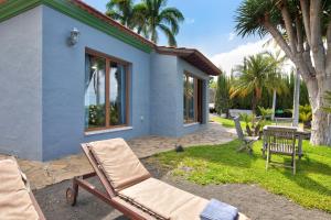 a blue house with a chair and a table at Villa Gorgonia in Tijarafe
