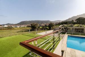 a balcony of a house with a swimming pool at Casa Do Chino in Esposende