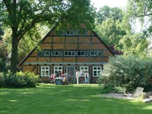 a group of people standing in front of a house at Historisches Haus Uhlenhorst in Trebel