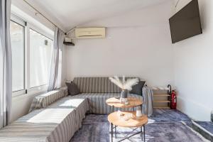 ein Wohnzimmer mit Sofa und Tisch in der Unterkunft Azure Nest in Néa Péramos